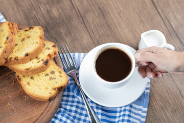 Sweet pie served with a cup of drink on a wooden board