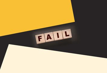 FAIL Word text Written In Wooden Cube blocks on black background. Business crisis concept