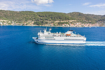 Aerial drone shot of ferry cruise leaving port in Adriatic sea in croatia summer