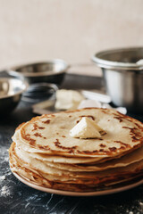 stack of pancakes with butter on white background