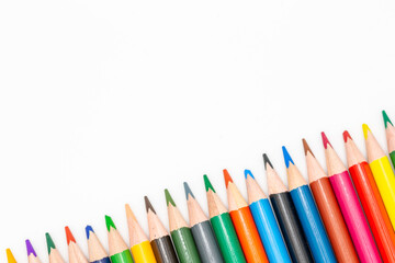set of crayons lined up in various colors with white background for school and arts with copy space for free text