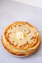 stack of pancakes with butter on white background