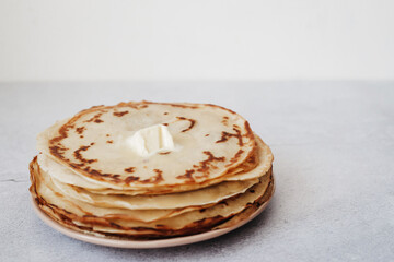 stack of pancakes with butter on white background