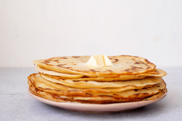 stack of pancakes with butter on white background