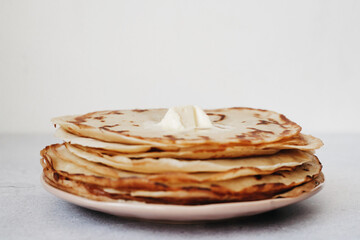 stack of pancakes with butter on white background