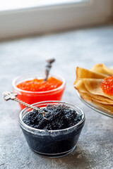 Russian traditional Maslenitsa: pancakes with red and black caviar