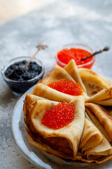 Pancakes with caviar. National Russian cuisine, the holiday of Maslenitsa.