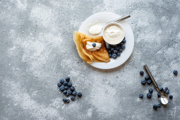 Pancakes with fresh strawberries and blueberries. National Russian cuisine, the holiday of Maslenitsa.