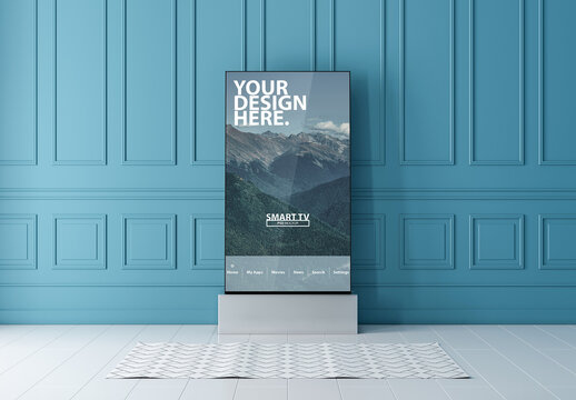 Modern Vertical Smart TV Mockup Standing Near Blue Wall