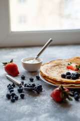 Pancakes with fresh berries. National Russian cuisine, the holiday of Maslenitsa.