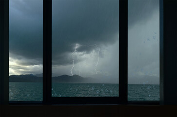 Rains and lightning over the mountains in the sea