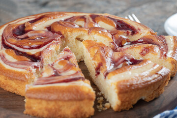 Sliced strawberry cake on a wooden board
