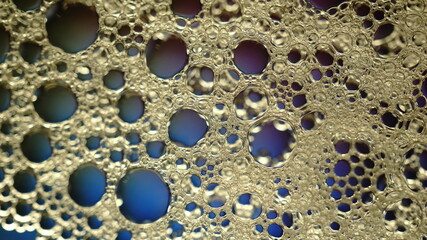 Oil bubbles in the water with some gradient backlight