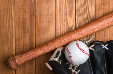 Baseball bat, glove and ball on wooden floor.  Sport theme background with copy space for text and advertisment