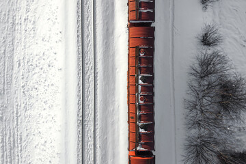 Aerial view of cargo train wagons, a double-track railway. Winter rail road with white snow, top view