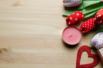 Romance. Valentine's Day. Handmade tulips, candle, paper heart on a wooden background.