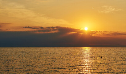 Amazing Sunset on the Sea. Adriatic sea, beautiful sunset, waves and landscape.  Lignano Sabbiadoro, Italy.