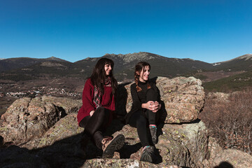 Two friends smiling on the mountain
