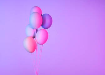 Multicolored eggs in the form of balloons on a purple background, Easter Background