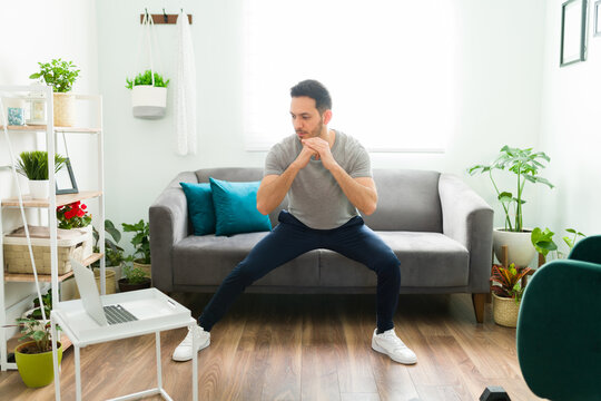 Adult Man With A Healthy Lifestyle Exercising At Home