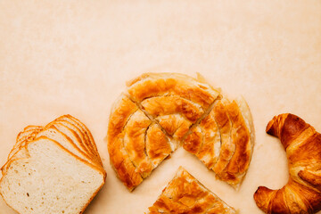 Chelsea bun, croissant and bread. Bakery products . Homemade large rolls of bread. Pastries for breakfast. Copy space