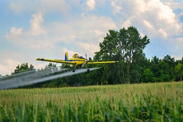 Yellow crop dusting airplane