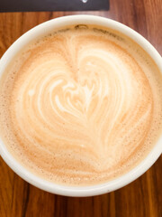 Close up of a milk foam in a coffee cup, in the shape of heart. Amazing Cappuccino.