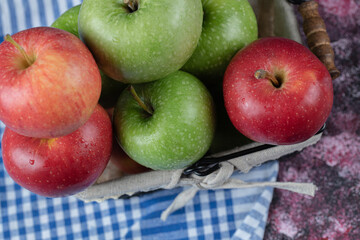 Apples in a basket covered with white towel