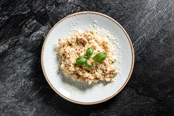 Delicious risotto with chicken stone background