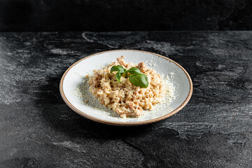 Delicious risotto with chicken stone background