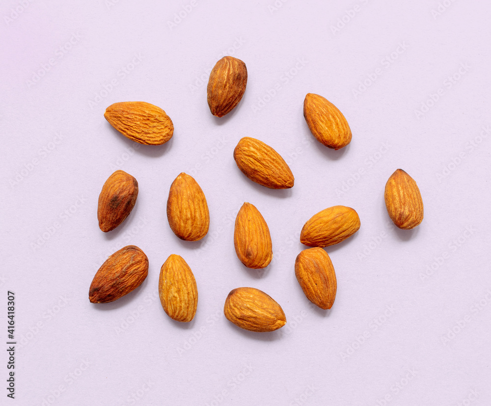 Sticker almonds on light purple background