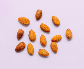 almonds on light purple background