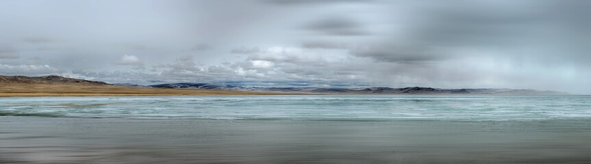 picturesque view of sea with rocky coast on background in morning