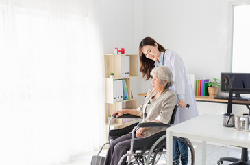 close up patient, Asian doctor drive a wheelchair of old patient, doctor and old female talk about disease symptoms and treatment plan, happy hospital, elderly healthcare promotion