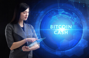 Business, Technology, Internet and network concept. Young businessman working on a virtual screen of the future and sees the inscription: Bitcoin cash