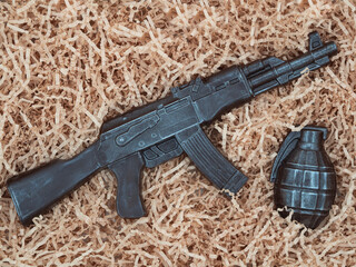 Food chocolate automatic rifle with an edible grenade in wood chips. Gift male set in a box for the...