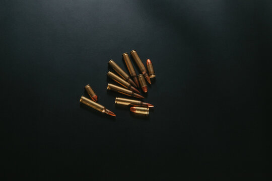 Bullet isolated on black background. Rifle pistol bullets close-up. Cartridges for pistol and carbine.