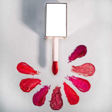 Lipstick gloss swatch with aplicator on marble 