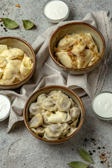 Dumplings with meat, potatoes and cottage cheese with sour cream and spices. Traditional Ukrainian and Russian dish.