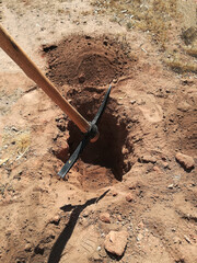 hole in the ground made with pick tool