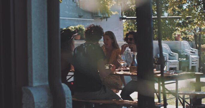 Attractive young people eating in a terrace