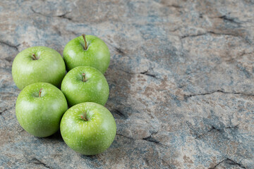 Green apples isolated on concrete background