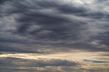 This image shows a dark sunset sky filled with clouds.