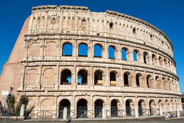 Fototapeta na wymiar An exterior view of the Roman Colosseum or Flavian Amphitheatre, an ancient structure which is the biggest amphitheatre built by the Roman Empire. One of the seven wonders of the world.