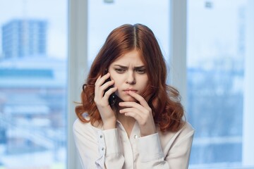 woman manager in office talking on the phone technology