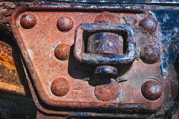 Detail textures of ancient iron bolts and metallic parts corroded in time from abandoned carriages of the old steam-engine Kingston Flyer training, New Zealand.