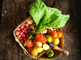 GRESIK CITY, EAST JAVA, INDONESIAN COUNTRY - February 25th, 2020: This photo was taken at noon. This is a photo of some of the vegetables pictured inside a woven bamboo container.