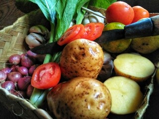 GRESIK CITY, EAST JAVA, INDONESIAN COUNTRY - February 25th, 2020: This photo was taken at noon. This is a photo of some of the vegetables pictured inside a woven bamboo container.