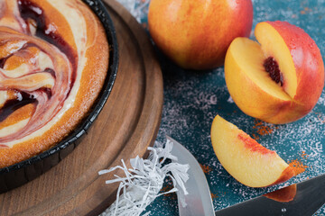 Strawberry syrup pie with yellow peaches around