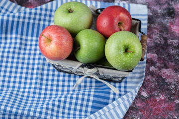 Apples in a basket with a white towel in it